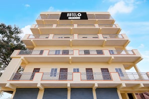 A multi-story hotel building with balconies on each floor. - Classic White Field CS (Bengaluru)