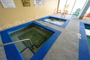 A pool area with multiple diving platforms and a lifeguard sign. - Wonderful 3  bedroom Unit at Sand Dunes Resort (Myrtle Beach)