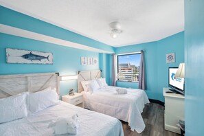 A hotel room with two beds, a television, and a view of the city. - Wonderful 3  bedroom Unit at Sand Dunes Resort (Myrtle Beach)