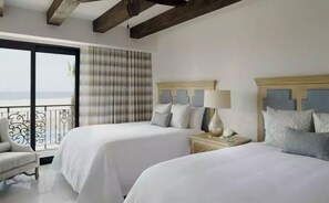 A hotel room with two beds, a balcony, and a view of the sea. - Spend Halloween in Cabo 2br/3bth condo Oct 31- Nov 7 (Cabo San Lucas)