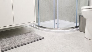 A modern bathroom with a glass-enclosed shower, a white toilet, and a beige cabinet. - Self-Contained, Full Kitchen, Full Bath, Private-A (Richmond Hill)