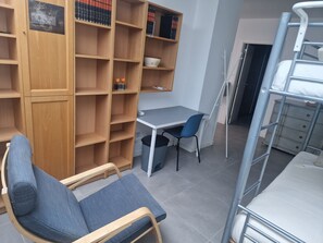 A study area with a desk, chair, and bookshelves. - Heading South Private Oasis (Quarteira)