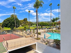 A rooftop pool area with a view of a residential neighborhood, including a tennis court and a swimming pool. - Cute San Clemente 1BDRM Condo - Minutes To Beach (San Clemente)