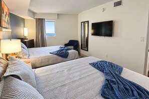 A hotel room with two beds, a TV, a mirror, and a window. - Family-Friendly 3BR | Indoor Pools & Arcade (Myrtle Beach)