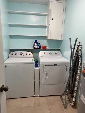 A laundry room with two front-loading washers, a cabinet above, and a drying rack to the right. - West Knox home w/Hot Tub and Fenced Backyard (Knoxville)