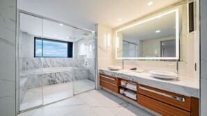 A modern bathroom with a glass shower enclosure, a large mirror, and marble flooring. - Incheon Grace Hotel (Incheon)