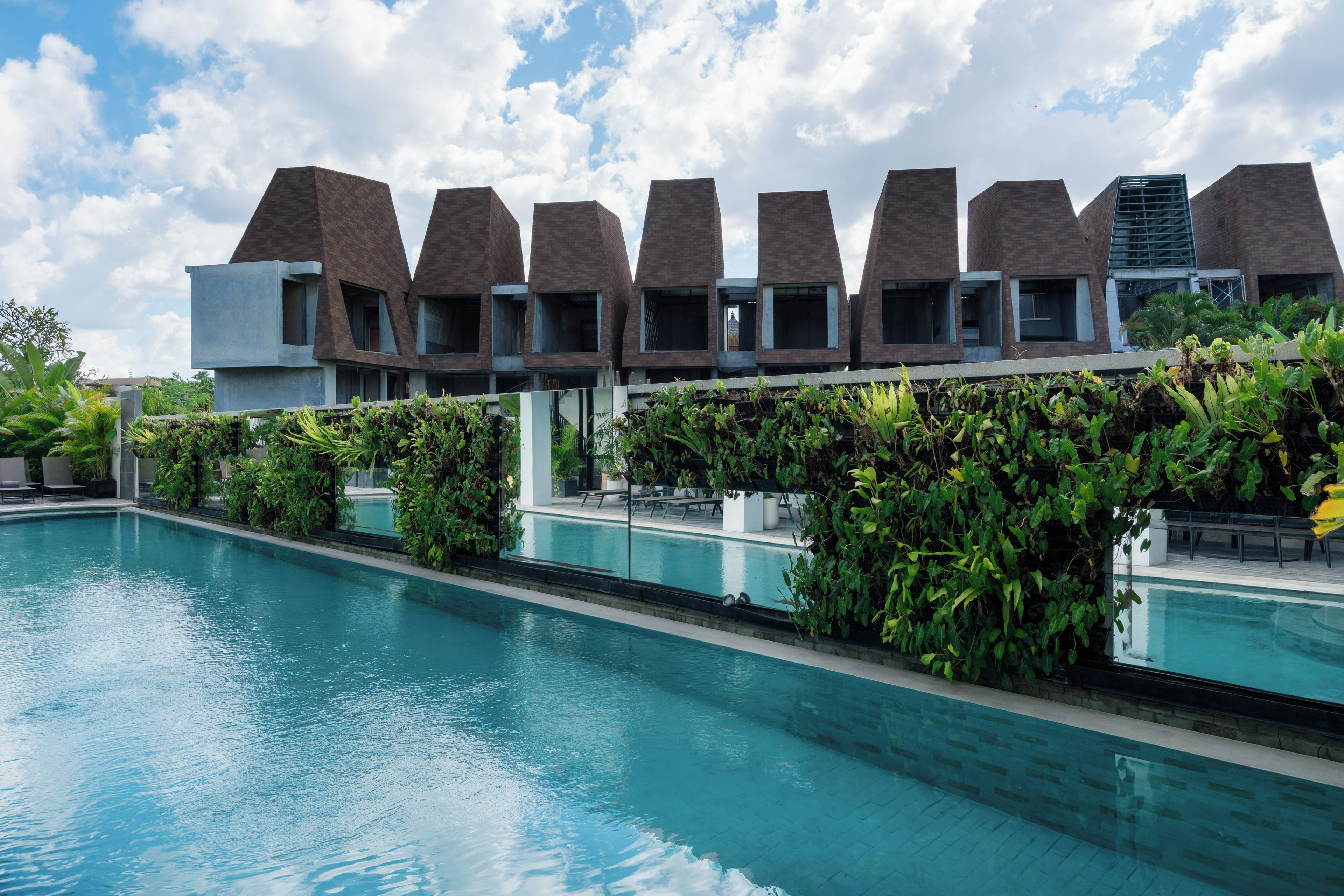 A modern building with a pool in front.