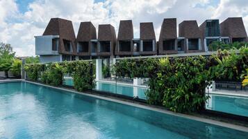 A modern building with a pool in front.