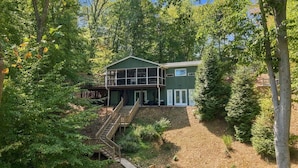A two-story house with a deck and a staircase leading to the entrance. - Elevated VIEWS, Outdoorsy Vibe, Speakeasy Kg Suite (Leasburg)