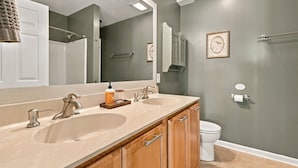 A bathroom with two sinks, a toilet, and a large mirror. - Elevated VIEWS, Outdoorsy Vibe, Speakeasy Kg Suite (Leasburg)