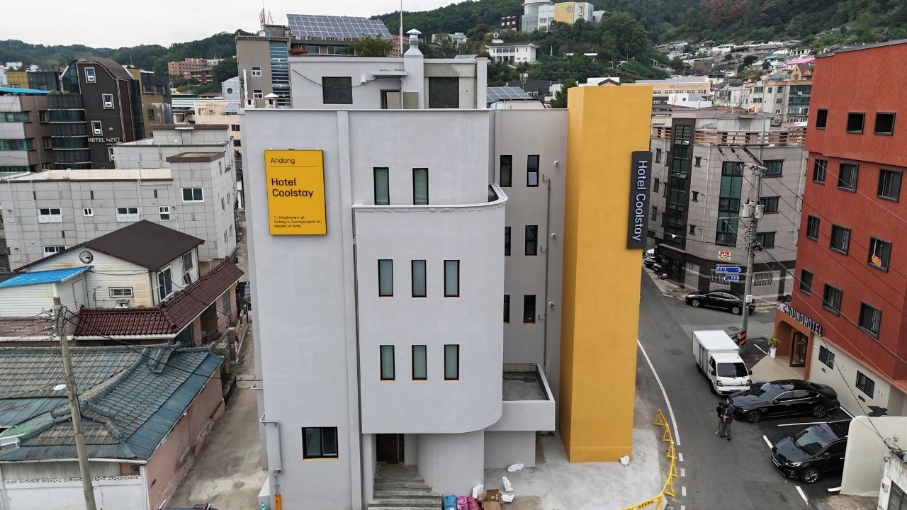 A multi-story hotel building with a sign indicating 'Andong Hotel Coolstay.'