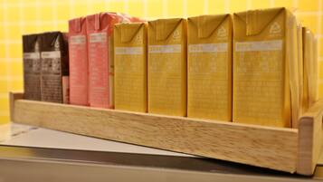 A shelf with cartons of beverages, likely milk or juice, in different colors.