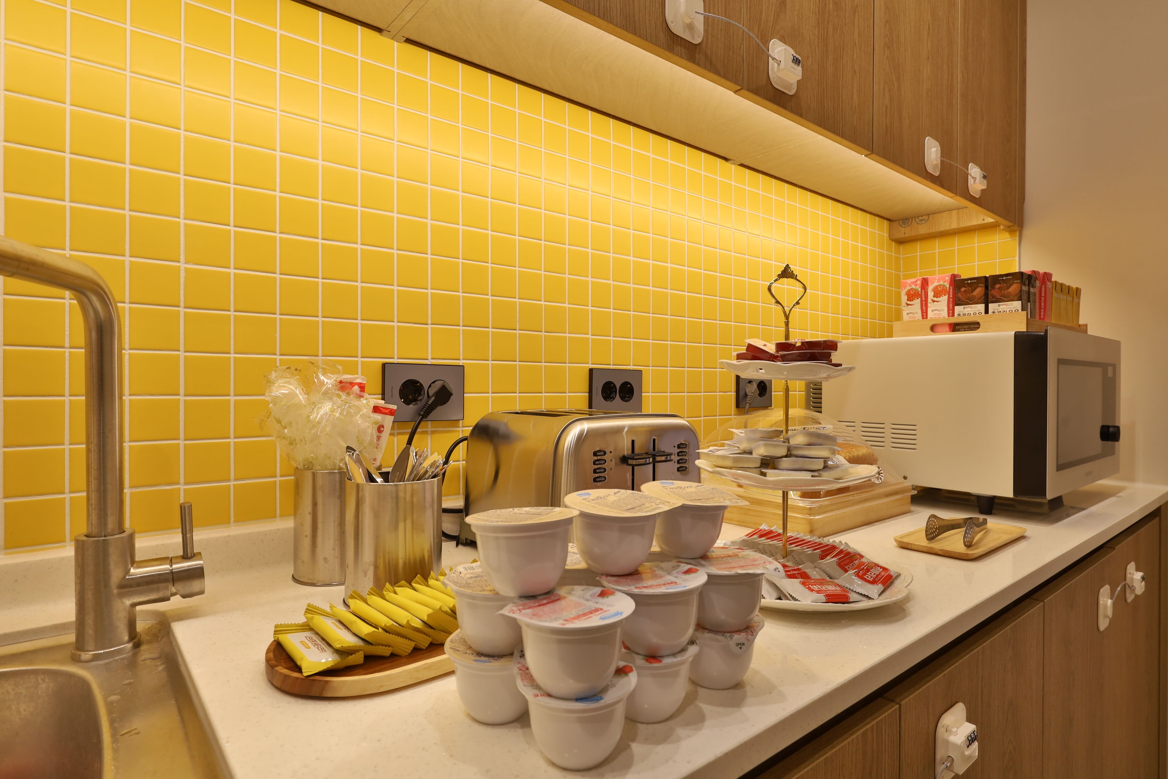 A kitchen counter with a toaster, a coffee machine, and various food items.