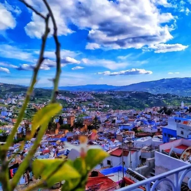 A cityscape with a view of buildings and a distant mountain range.