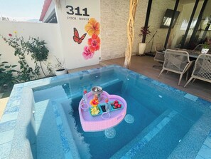 A pool area with a hot tub, a table with fruit and drinks, and a sign reading '311 POOL HOUSE'. - Pool House 311 by Diana (Jocotepec)