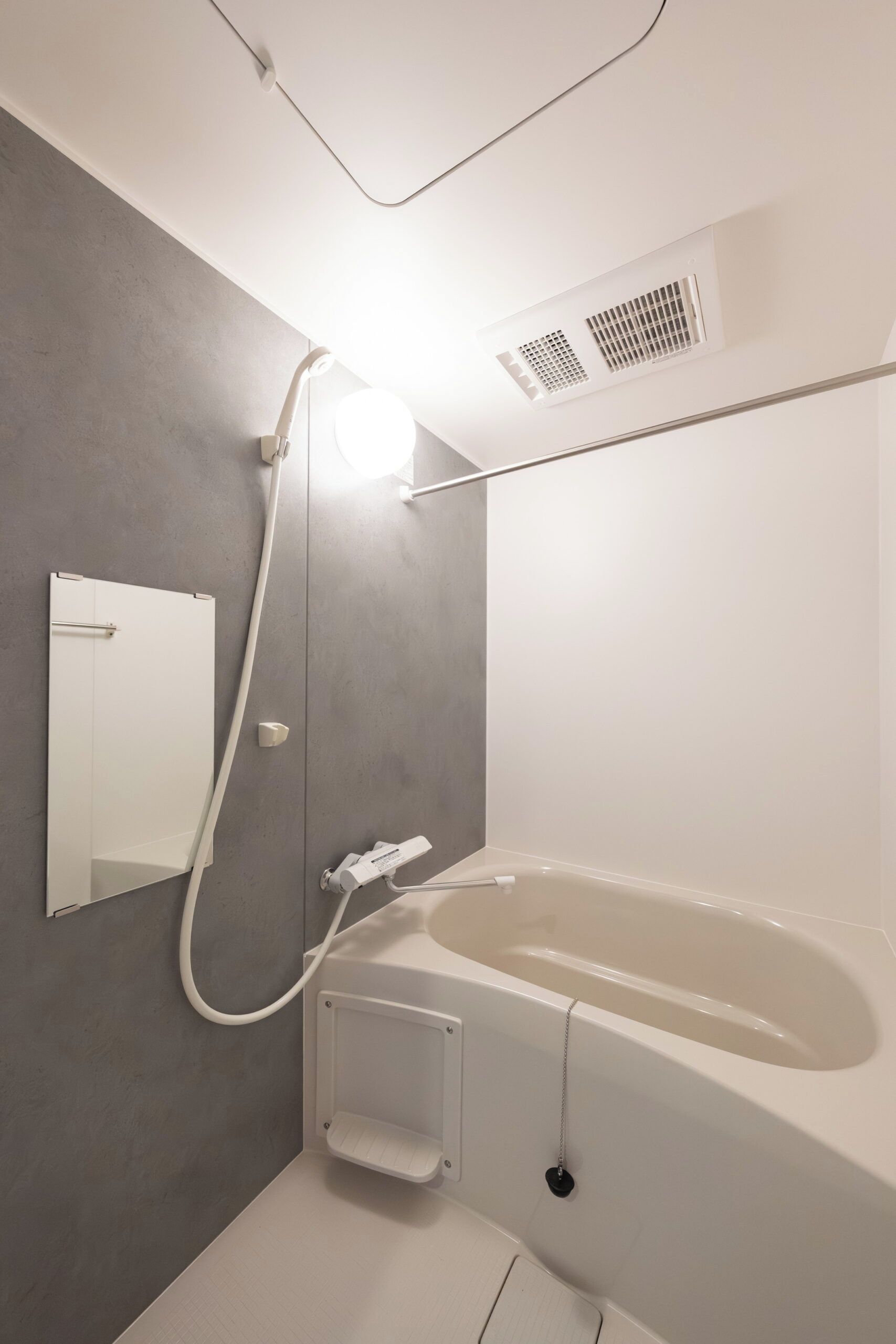 A modern bathroom with a bathtub, a shower, and a toilet.