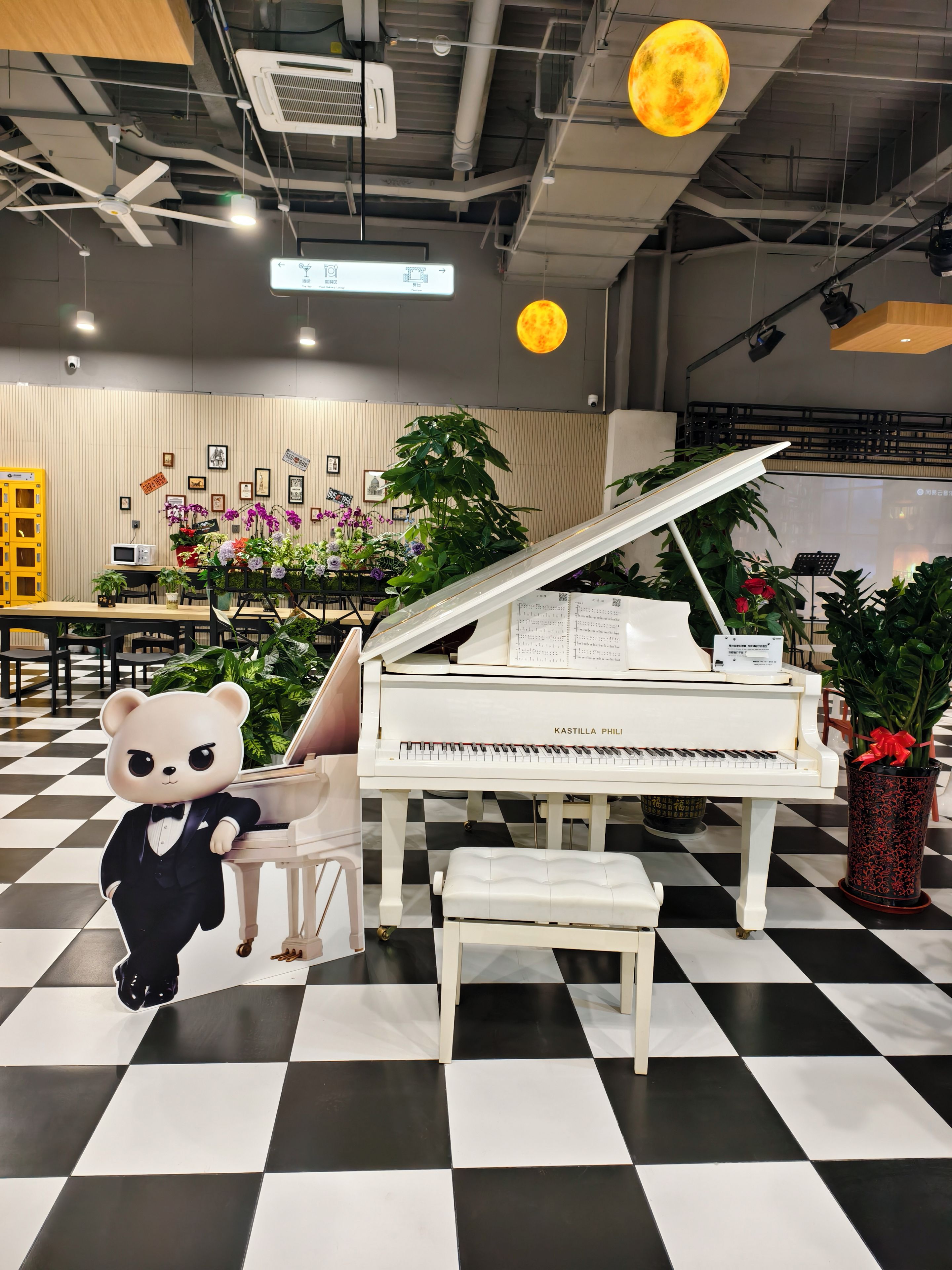 A room with a grand piano, a bear statue, and a checkered floor.