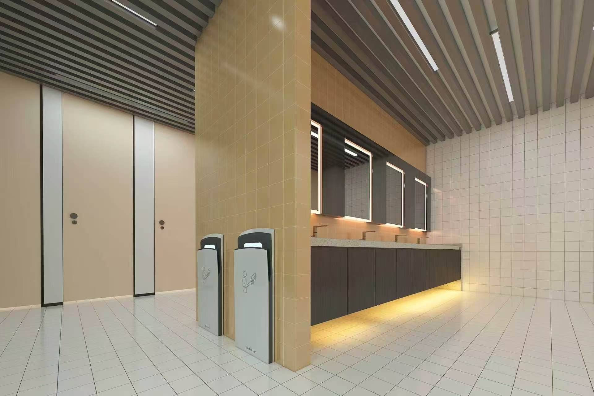 A modern restroom with a long counter, two hand dryers, and a mirror above the sink.