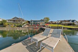A waterfront property with a dock, lounge chairs, and a small pool. - The Red Lake House | Beach & Dock Access (Chelan)