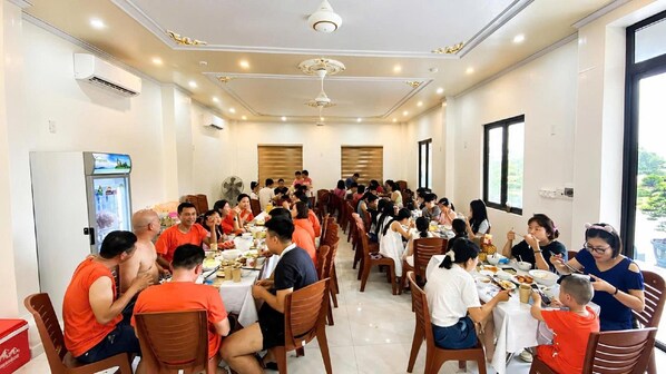 A dining area with tables and chairs arranged for guests.