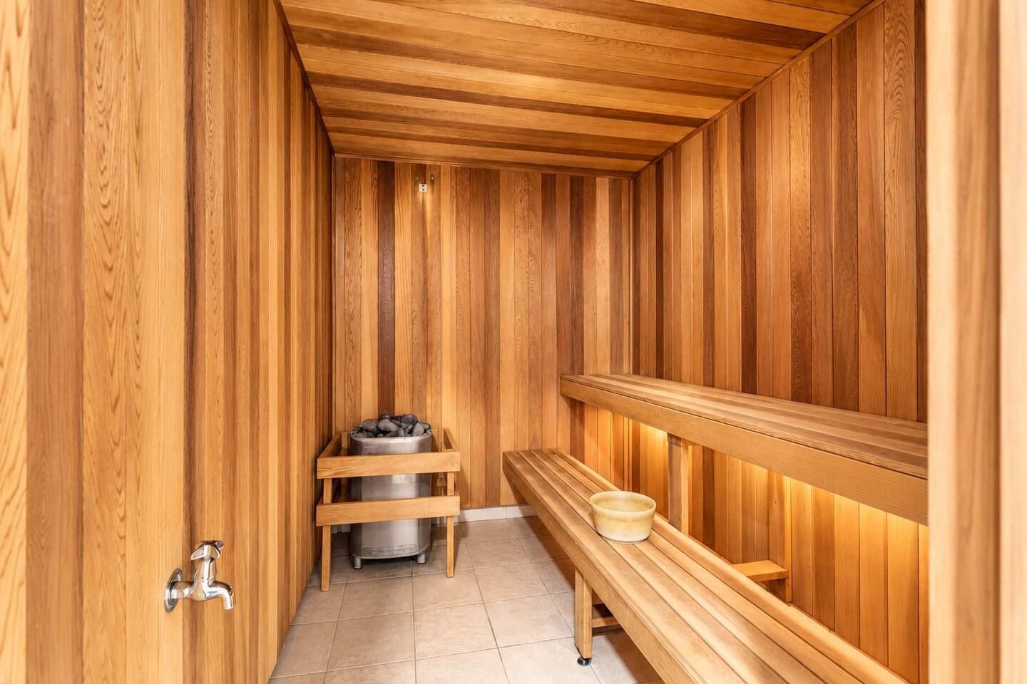 A sauna with wooden walls and benches.
