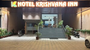 The entrance of Hotel Krishvana Inn with a staircase leading to the lobby.