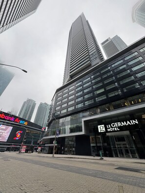 A modern building with a prominent 'Le Germain Hotel' sign, large windows, and a street in front. - Condo downtown toronto near Scotiabank arena (Toronto)