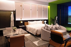 A modern hotel room with a bed, seating area, and a television. - Sakki Golf Resort (Shenzhen)