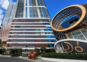 A modern hotel with a curved facade, a prominent circular entrance, and a visible sign for a theater. - The Paramount Nha Trang by San Village (Bac Nha Trang)