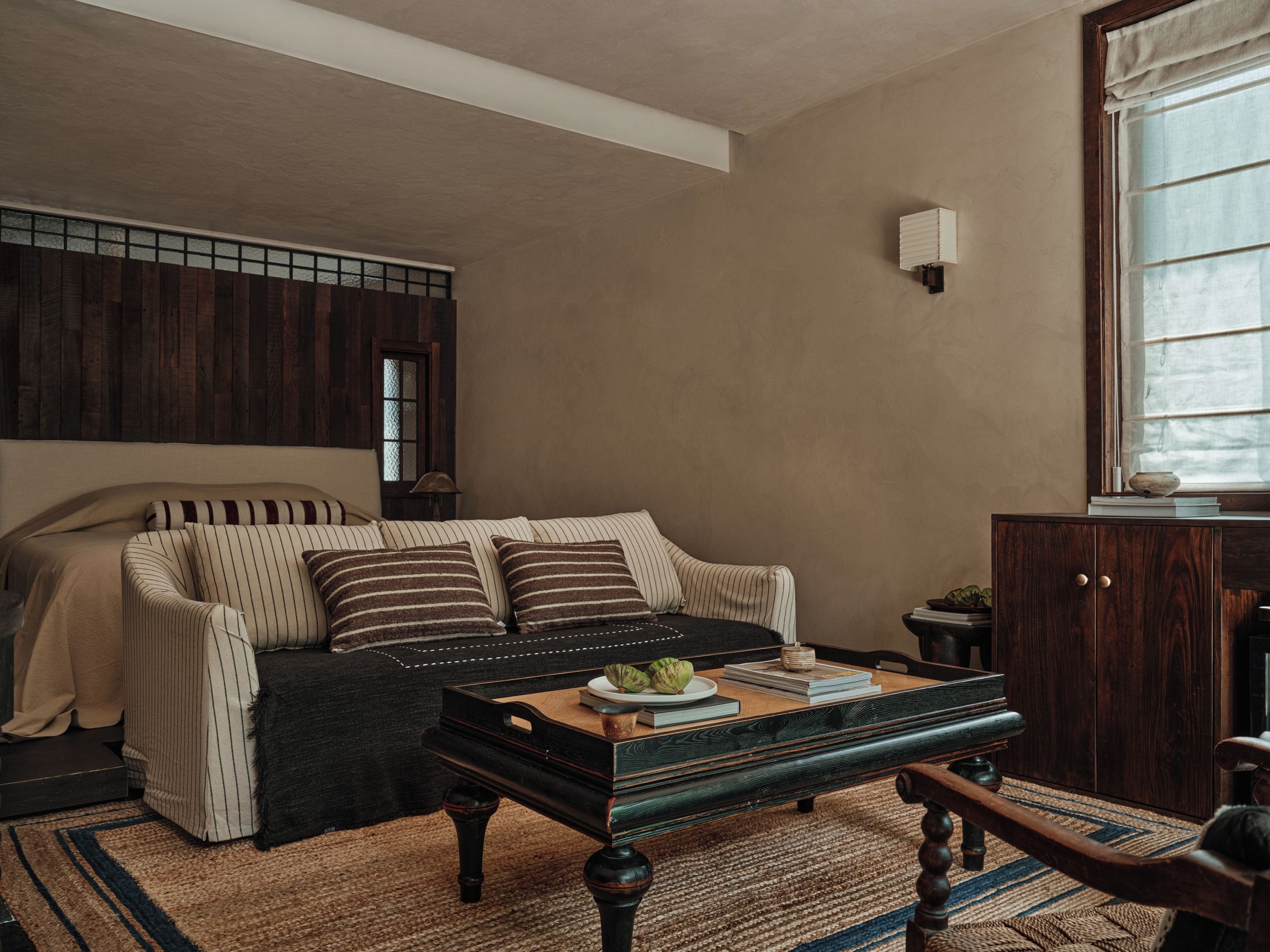 A cozy room with a sofa, a wooden coffee table, and a cabinet.