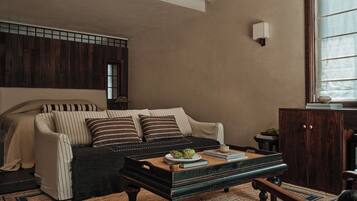 A cozy room with a sofa, a wooden coffee table, and a cabinet.