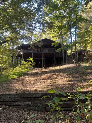 A wooden cabin with a balcony, surrounded by trees and a forested area. - Mountain Refuge “Lord, You have been our refuge in every generation.”Ps 90:1 (Franklin)