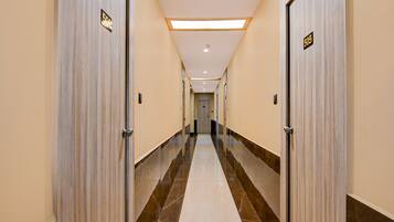 A hotel corridor with doors numbered 506 and 505, leading to a room with a view.
