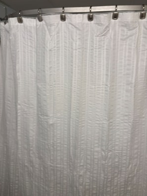 A white curtain with a textured pattern, likely part of a room's window treatment. - Driftwood Studio | Steps to South Myrtle Beach ,Bright, Cozy & Self Check-In (Myrtle Beach)
