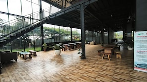 A spacious indoor area with a wooden floor, large windows, and a staircase. - Andong Valley (Ngablak)