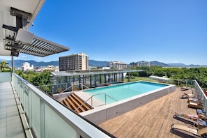 A rooftop pool with a clear view of the city and mountains in the background. - Belle Escapes 1104 Harbour Lights Top Floor Ocean & City Views (Cairns City)