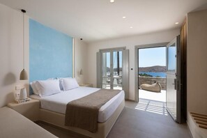 A modern bedroom with a large bed, a nightstand, a reading lamp, and a view of the outdoors through a glass door. - Gea Perla Serifos (Serifos)