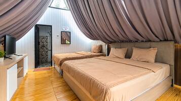 A bedroom with two beds, a TV, and a shower area.