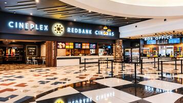 A Cineplex with a Redbank logo, a Box Office, and a seating area with a checkered floor pattern.