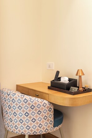 A hotel room with a wooden desk, a patterned chair, a remote control, a tissue box, a lamp, and a 'No Smoking' sign. - HOTEL DAAAS KATHMANDU (Kathmandu)