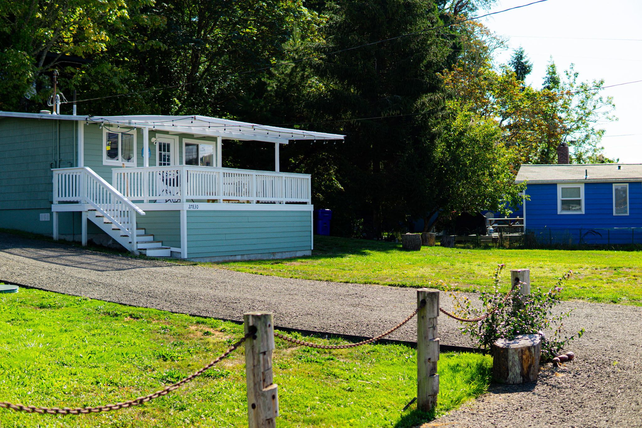 A small, single-story building with a porch and a staircase leading to the entrance.