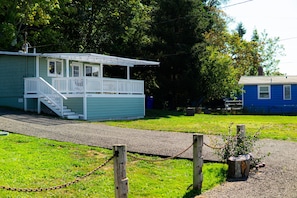 A small, single-story building with a porch and a staircase leading to the entrance.