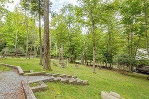 A campground with picnic tables, a swing set, and a stone fire pit area. - 2 Mi to Beech Mtn Resort Lifts: Family Home (Beech Mountain)