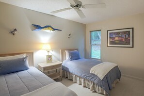 A bedroom with two beds, a ceiling fan, a window with a view, and a framed picture on the wall. - 2 Mi to Beech Mtn Resort Lifts: Family Home (Beech Mountain)