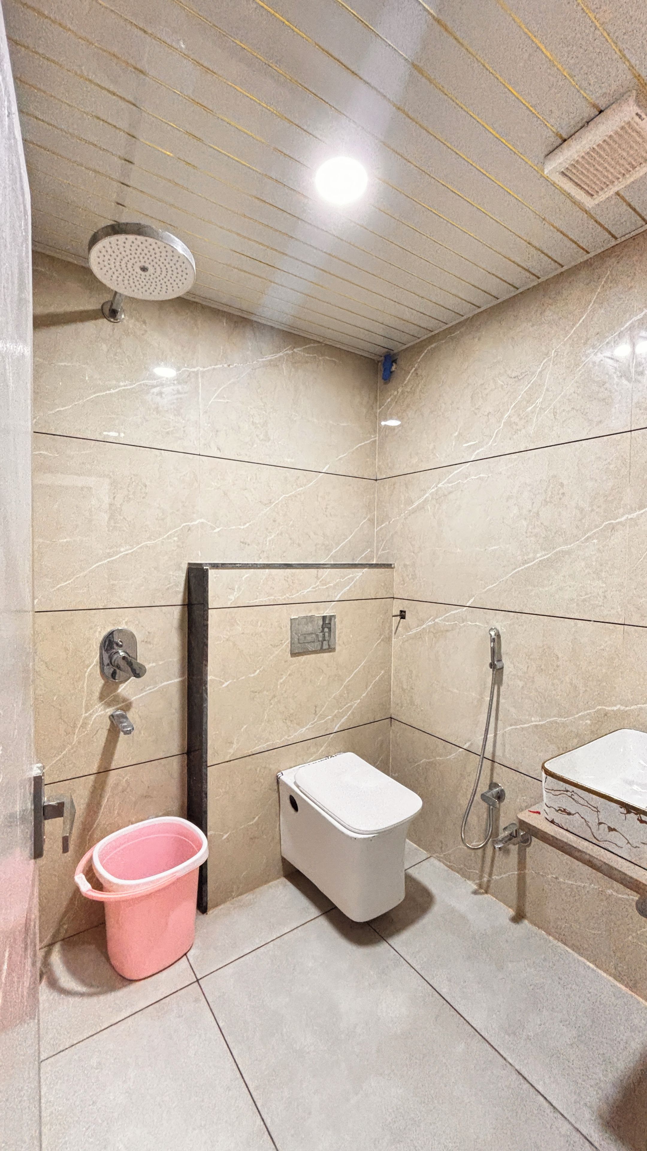 A bathroom with a shower, toilet, and sink.