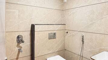 A bathroom with a shower, toilet, and sink.