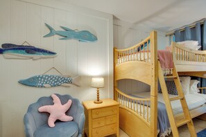 A children's room with a bunk bed, a starfish chair, and fish wall art. - Access to Pool & Sanibel Beach: Resort-Style Condo (Sanibel)
