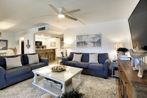 A modern living room with two sofas, a coffee table, and a ceiling fan. - Access to Pool & Sanibel Beach: Resort-Style Condo (Sanibel)