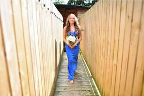 A person walking down a wooden pathway.