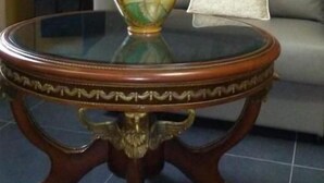 A round table with a vase and a cushion on a sofa in a room with a sloped ceiling. - Animosa Suite (Castiglione di Sicilia)